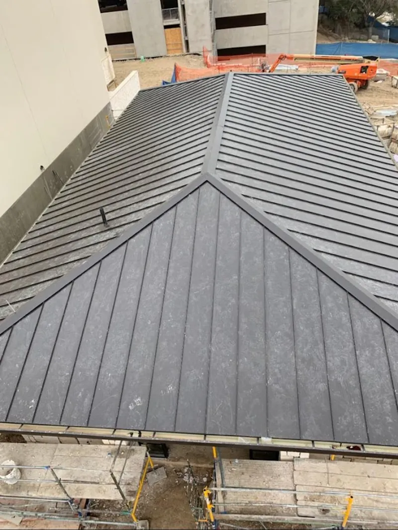 Commercial metal roof construction with crane equipment in La Grange