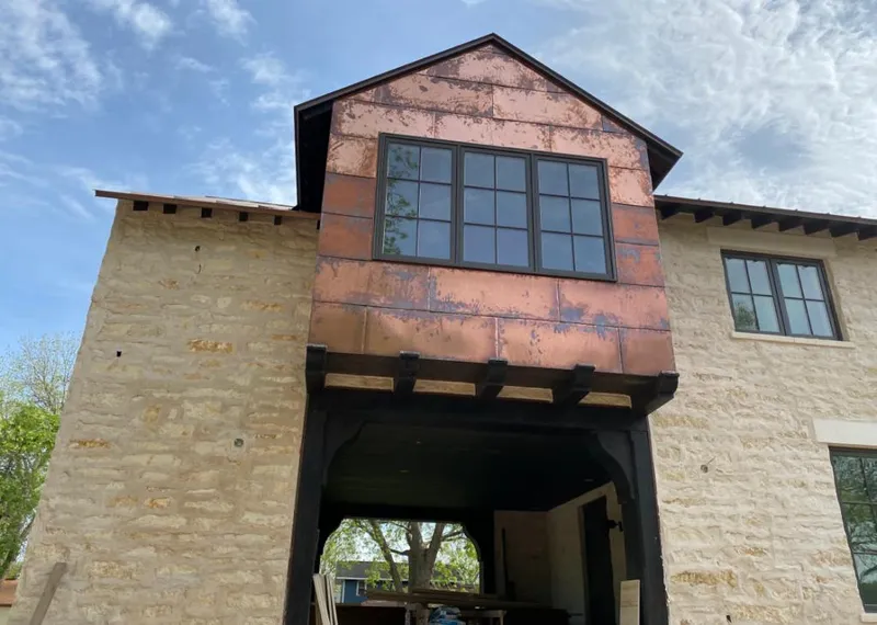 Copper metal panel facade on a stone building for Skylight Installation in La Grange